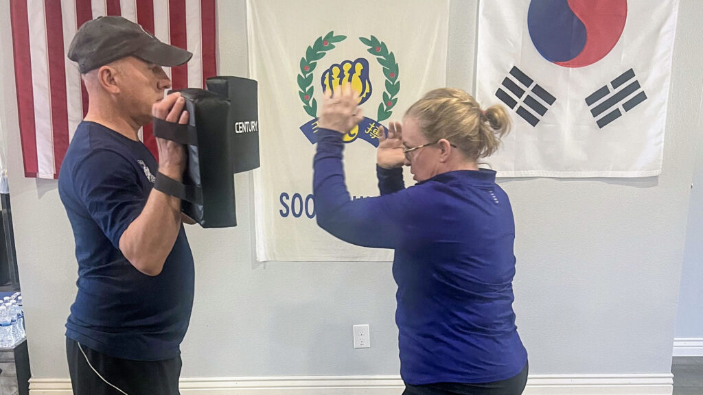 Two people practicing self-defense at Rocky Mountain Sports Club
